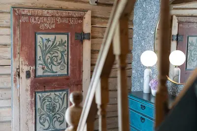 a wooden door in a room with a dresser at Østigård 1810 in Åndalsnes