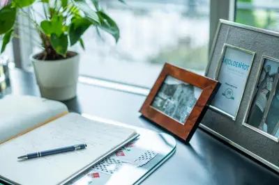 a desk with a pen and a picture and a book at Skjolden Hotel in Skjolden