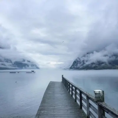 a wooden dock on a body of water at Skjolden Hotel in Skjolden