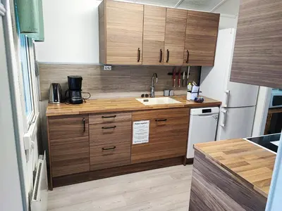 a kitchen with wooden cabinets and a white refrigerator at Visit Undredal in Undredal