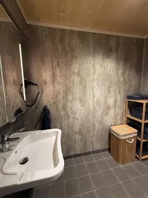 a bathroom with a white sink in a room at Blue House Dormitory in Odda