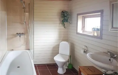 a bathroom with a tub and a toilet and a sink at Nice Home In Valen With Wifi in Valen