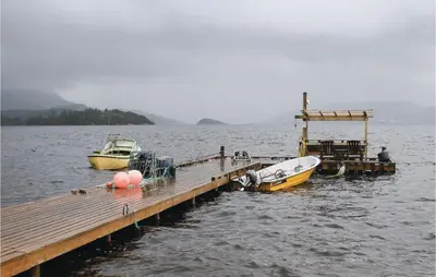 two boats are docked at a dock in the water at Nice Home In Valen With Wifi in Valen