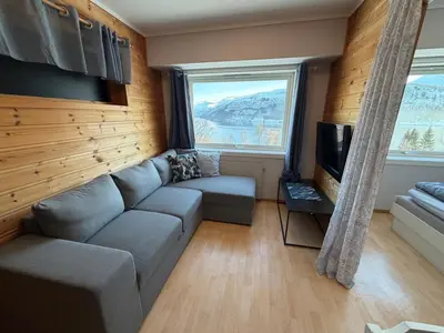 a living room with a couch and a tv at Studio Apartment in Haukedalen in Førde