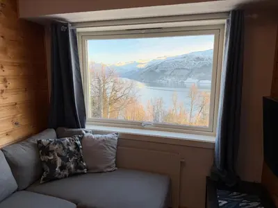 a large window with a view of a lake at Studio Apartment in Haukedalen in Førde