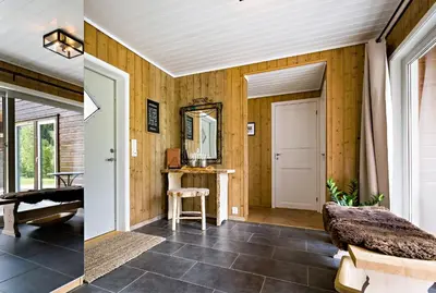 a room with wooden walls and a door and a mirror at Riverside in Hornindal