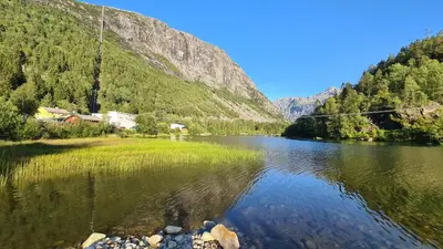 a view of a river with mountains in the background at Trolltunga Lodge in Odda