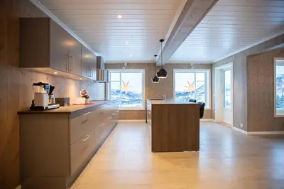 a kitchen with a island in the middle of a room at Rolfhytta - Fosskamben 19 in Sogndal