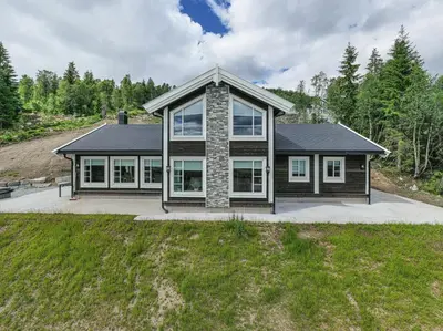 a house with a lot of windows at Rolfhytta - Fosskamben 19 in Sogndal