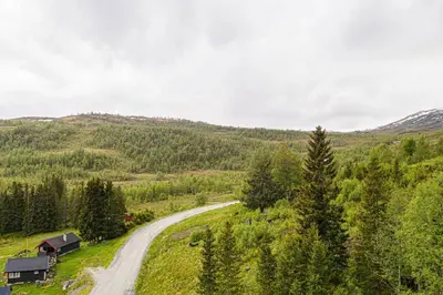a dirt road in the middle of a mountain at Rolfhytta - Fosskamben 19 in Sogndal