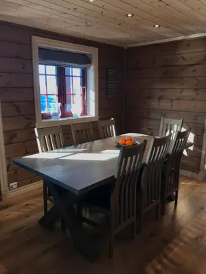 a wooden dining room with a table and chairs at Harpefossen Skisenter og Hyttegrend in Nordfjordeid