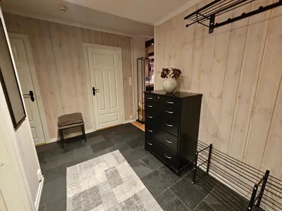 a room with a black dresser with a vase on it at Leilighet Gaustablikk in Rjukan