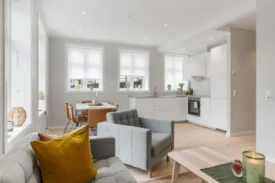 a living room with a couch and a table at Barfot Apartments in Bergen