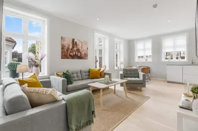 a living room with a couch and a table at Barfot Apartments in Bergen