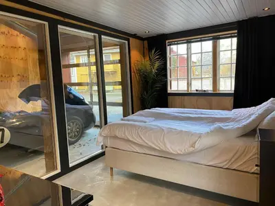 a bedroom with a bed and a view of a car at Lærdalsøren Motor Guesthouse in Lærdalsøyri