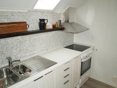a small kitchen with a sink and a stove at Siloen - cosy apartment in Herand in Herand