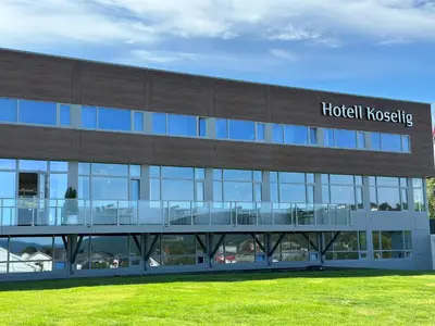 a hospital building with a hospital hugging sign on it at Hotell Koselig in Kyrksæterøra