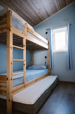 two bunk beds in a room with a window at Fossen Accommodation in Geiranger