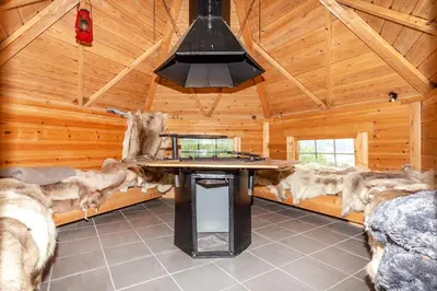 a large room with a table in a log cabin at Modern Apartment with panorama wiew in Blakset