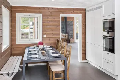 a dining room with a table and chairs at Pudderhytta in Sogndal