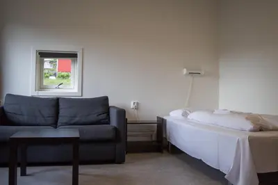 a living room with a couch and a bed and a window at Sogndal Bed & Breakfast in Sogndal