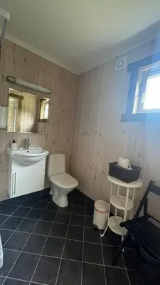 a bathroom with a white toilet and a sink at BUDGET Kvamseter Lodge in Eikedalen
