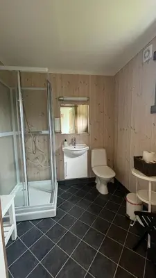 a bathroom with a shower and a toilet and a sink at BUDGET Kvamseter Lodge in Eikedalen