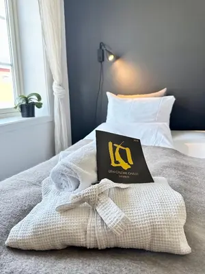 a book sitting on top of a bed at SAGA, unikt badehotell med 5 rom, sauna og badebrygge - Inderøy in Straumen