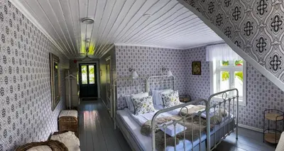 a bedroom with two bunk beds in a room with wallpaper at Haaheim Gaard in Uggdal