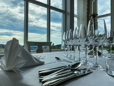 a table with wine glasses and silver utensils on it at Haaheim Gaard in Uggdal