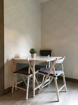 a table and chairs with a potted plant on it at Kvamseter Lodge - Mountain Apartments in Norheimsund
