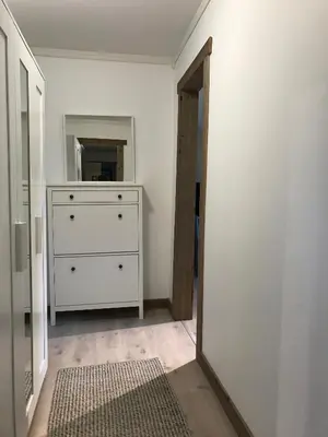 an empty room with a dresser and a mirror at Kvamseter Lodge - Mountain Apartments in Norheimsund
