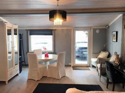 a living room with a table and chairs and a couch at Kvamseter Lodge - Mountain Apartments in Norheimsund