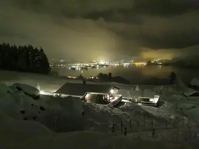 a view of a city at night in the snow at Etne Hytter in Etnesjøen