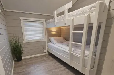 a bedroom with two bunk beds and a window at Etne Hytter in Etnesjøen