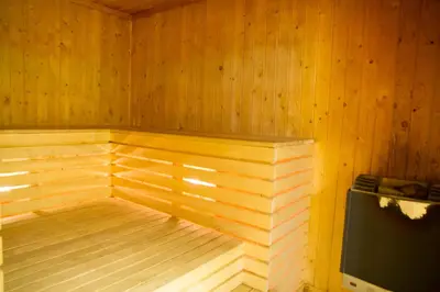 a wooden sauna with a bench in a room at Basecamp Frich`s Hjerkinn in Hjerkinn
