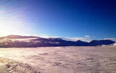 a view of a snowy field with mountains in the background at Basecamp Frich`s Hjerkinn in Hjerkinn