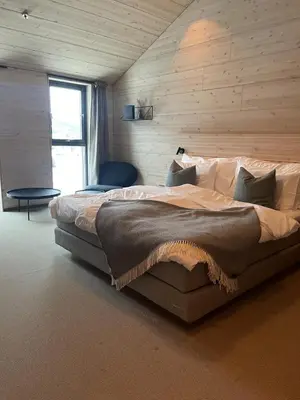 a bedroom with a large bed and a window at BrimiBue Hotel in Lom
