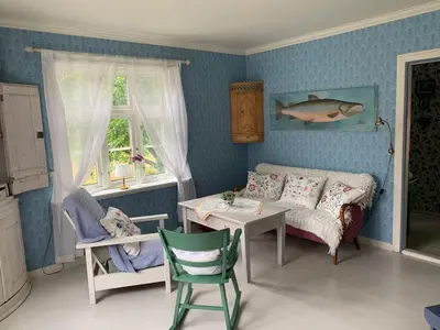 a childs bedroom with a bed and a table and chairs at Aobrio Holidayhouse, authentic norwegian farmhouse close to Flåm in Lærdalsøyri