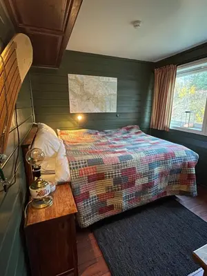 a bedroom with a bed and a table and a window at Storehorn Apartments Hemsedal in Hemsedal