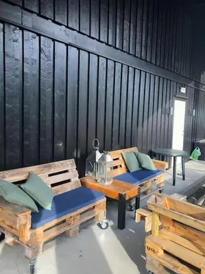 a room with two benches and a table with pillows at Storehorn Apartments Hemsedal in Hemsedal