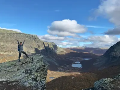 a man standing on the edge of a mountain at Storehorn Apartments Hemsedal in Hemsedal