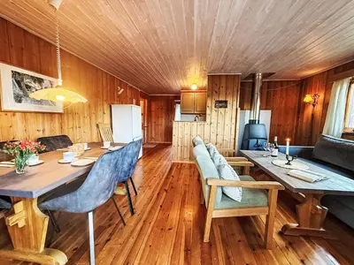a dining room with a long table and chairs at Holiday Home Turken by Interhome in Kaupanger