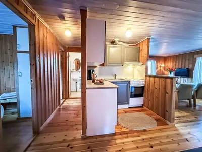 a kitchen with wooden walls and wooden floors at Holiday Home Turken by Interhome in Kaupanger