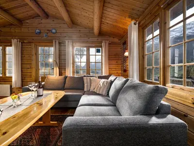 a living room with a couch and a table at Chalet Fjordblick I by Interhome in Olden