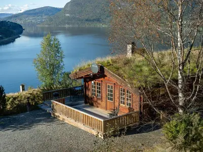 a small cabin on the side of a lake at Chalet Fjordblick I by Interhome in Olden