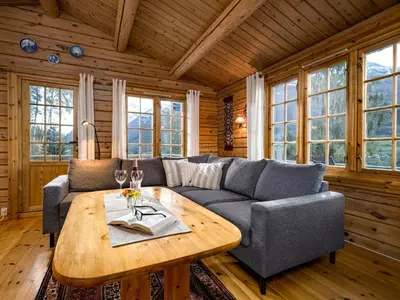 a living room with a couch and a table at Chalet Fjordblick I by Interhome in Olden
