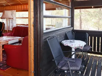 a porch with two chairs and a table and a couch at Holiday Home Sandvikfjellet by Interhome in Nyttingsnes