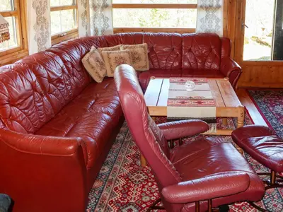 a leather couch and a coffee table in a living room at Holiday Home Sandvikfjellet by Interhome in Nyttingsnes