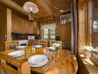 a wooden table in a kitchen with a dining room at Holiday Home Lona by Interhome in Viksdalen